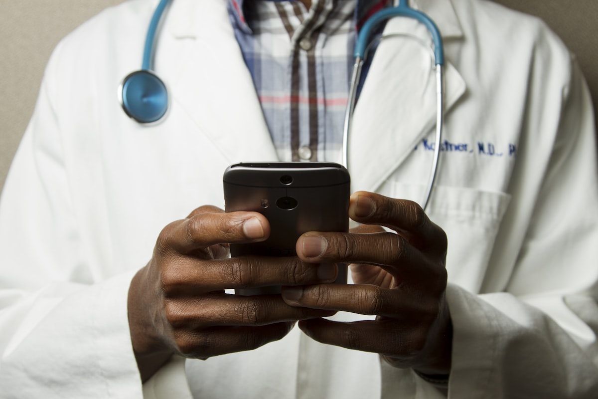 Doctor demonstrating medical telehealth chart on screens