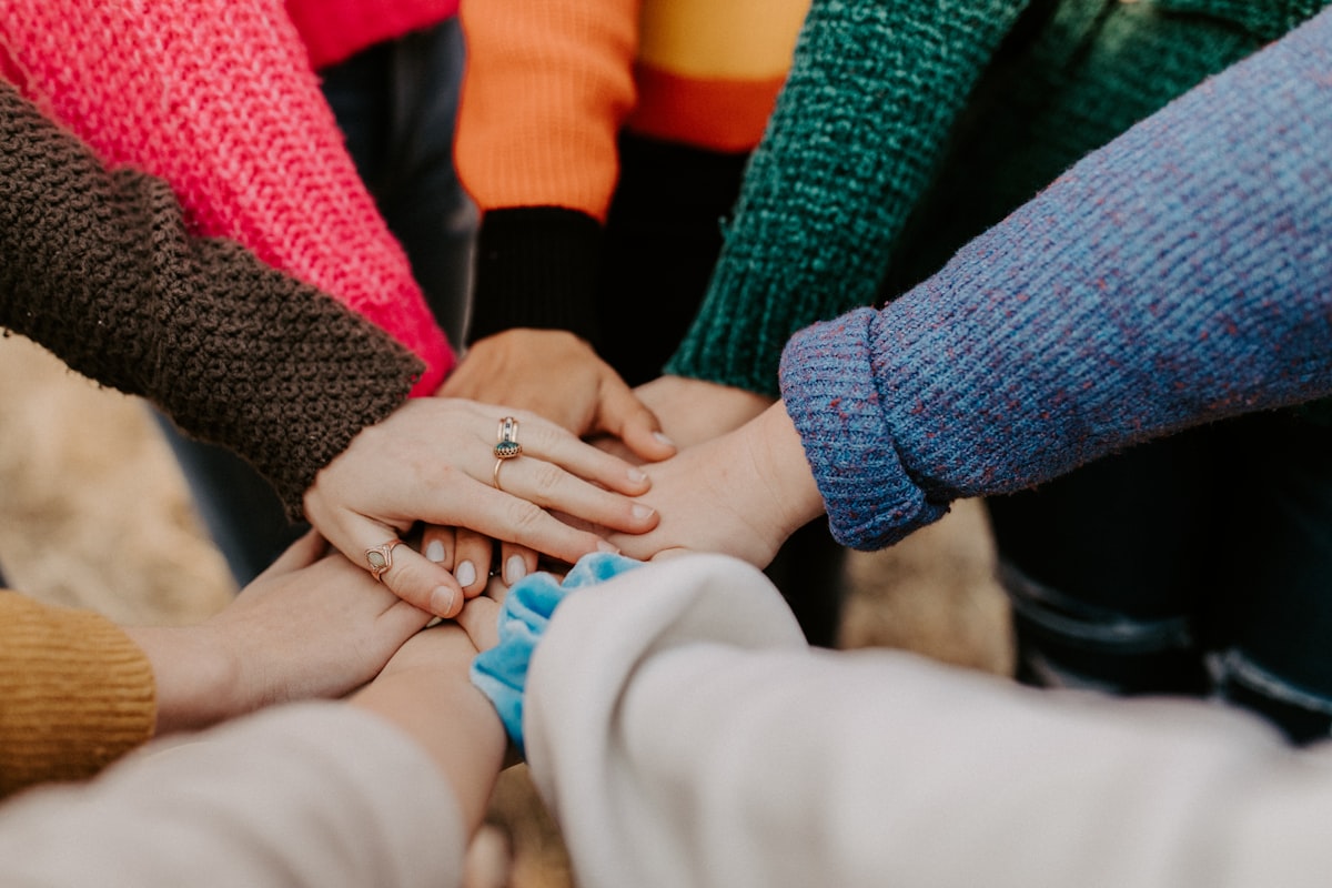 Group of people holding hands to represent community health support